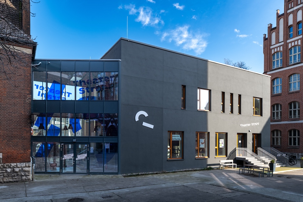 bäude von außen. Altes Backsteingebäude neben modernem Anbau.